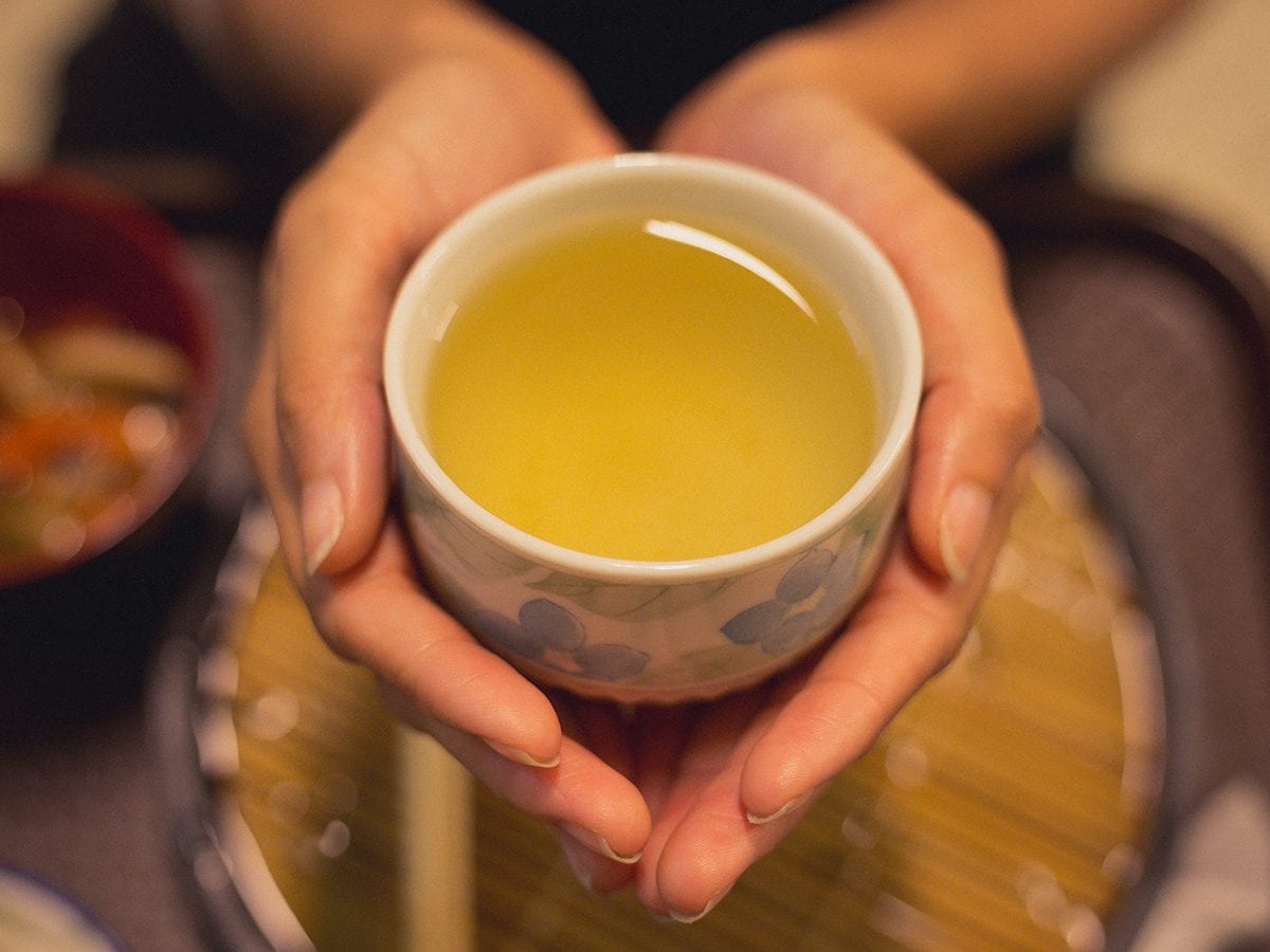 Green-tea-woman-holding-cup
